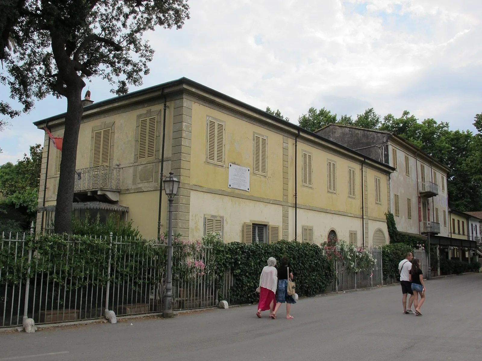 La Villa Museo Giacomo Puccini a Torre del Lago, edificio giallo con persiane e cancellata coperta di verde lungo il viale